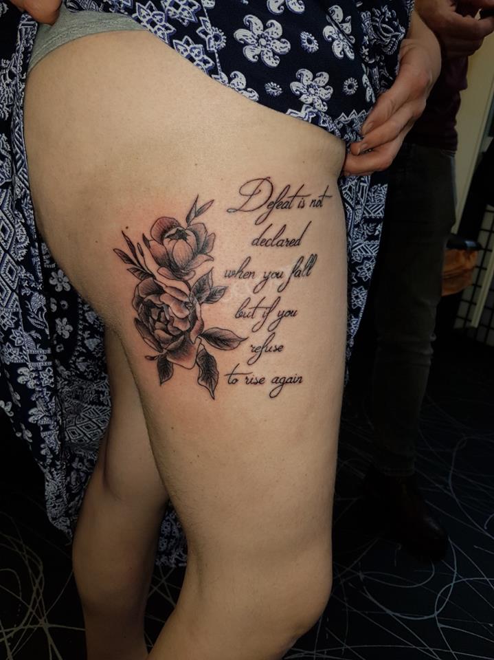 pretty girly flower tattoo on thigh